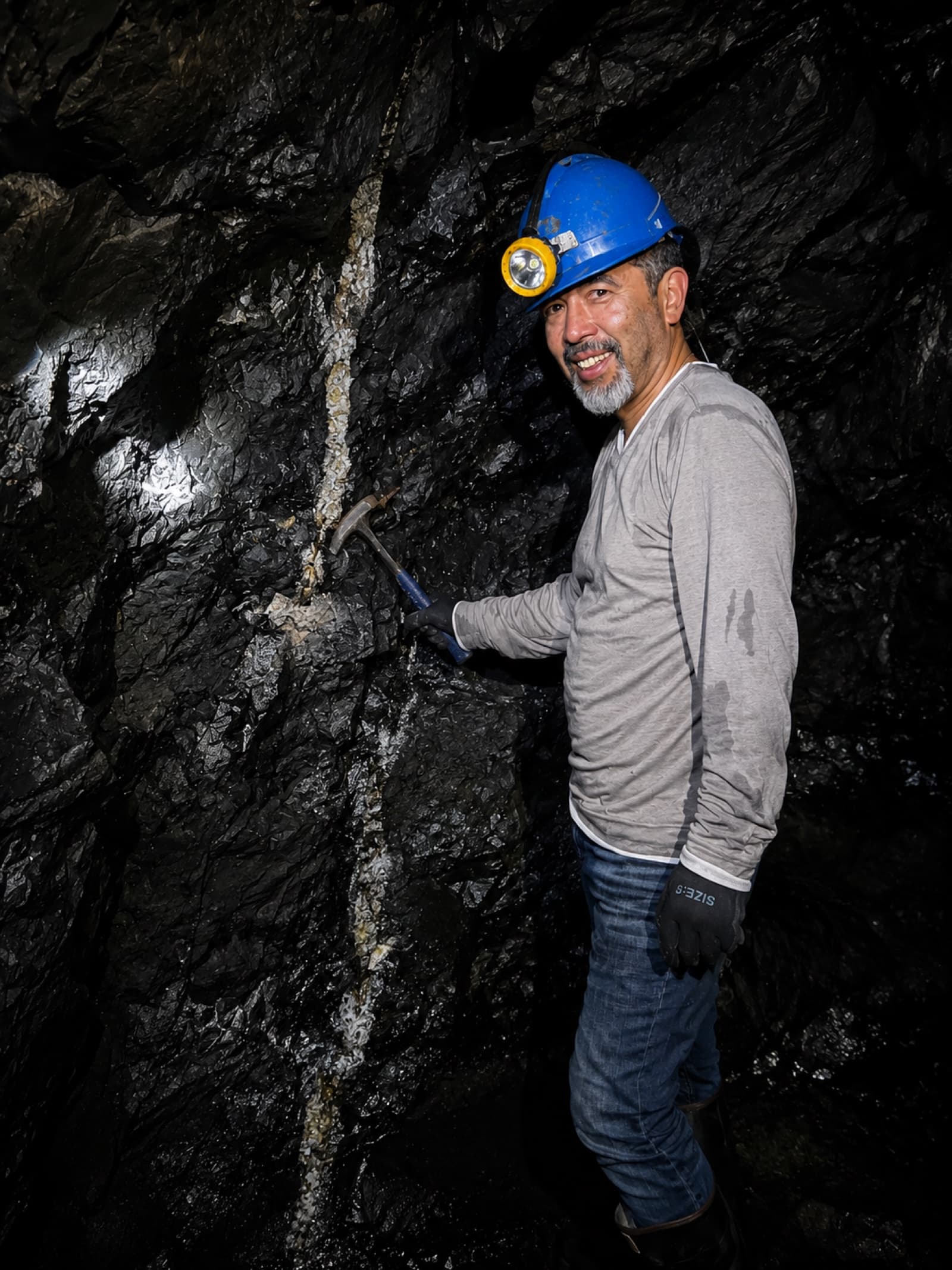 Darwin Sandoval working a white calcite vein inside an emerald mine